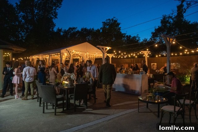 Outdoor Wedding Tent Decorated with Lush Greenery and Elegant Lighting