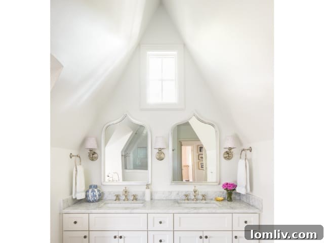 A contemporary open-plan kitchen with dark cabinetry, a large central island, and modern bar stools, flowing into the living area.