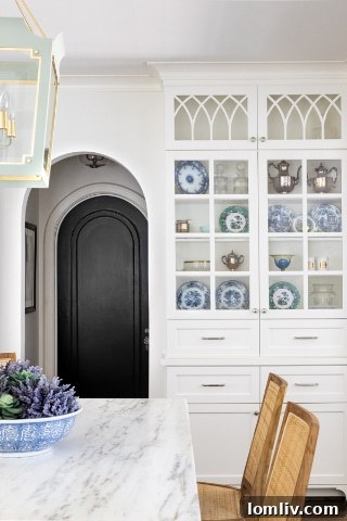 The bright and airy family room with comfortable seating, a large rug, and access to the modern kitchen, creating a cohesive living space.