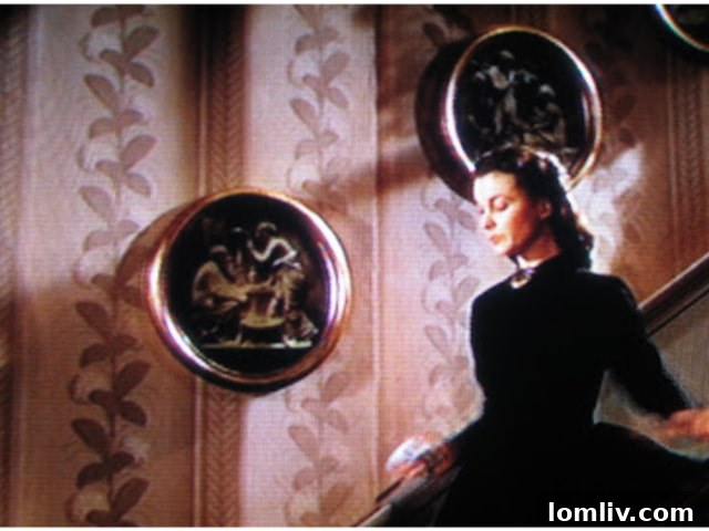 The elegant dining room featuring the historic Schumacher Hydrangea Drape wallpaper, a classic chandelier, and a formal dining set.