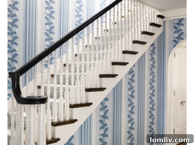 Ben's elegant home office, painted in a rich blue, featuring a classic desk, a comfortable chair, and art on the walls.