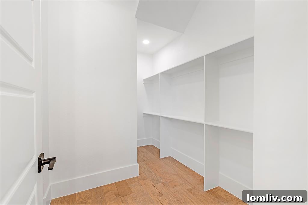Luxurious master bathroom with marble tiling and dual vanities
