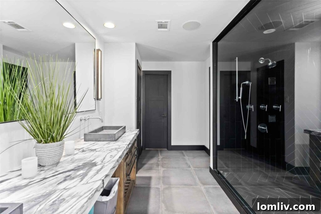 Luxurious Master Bathroom with Concrete Floors and Marble Countertops