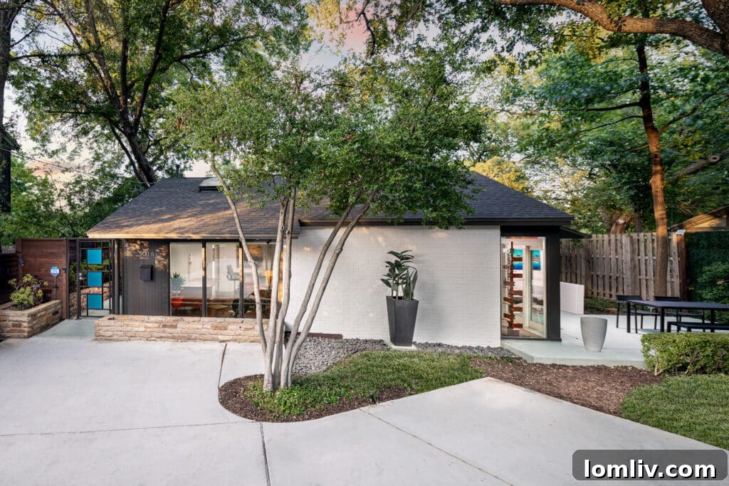 Exterior view of a historic Midcentury Modern home with expansive glass and a flat roof