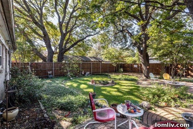 Detailed view of the new board-on-board fence with decorative cutouts and swing gate.