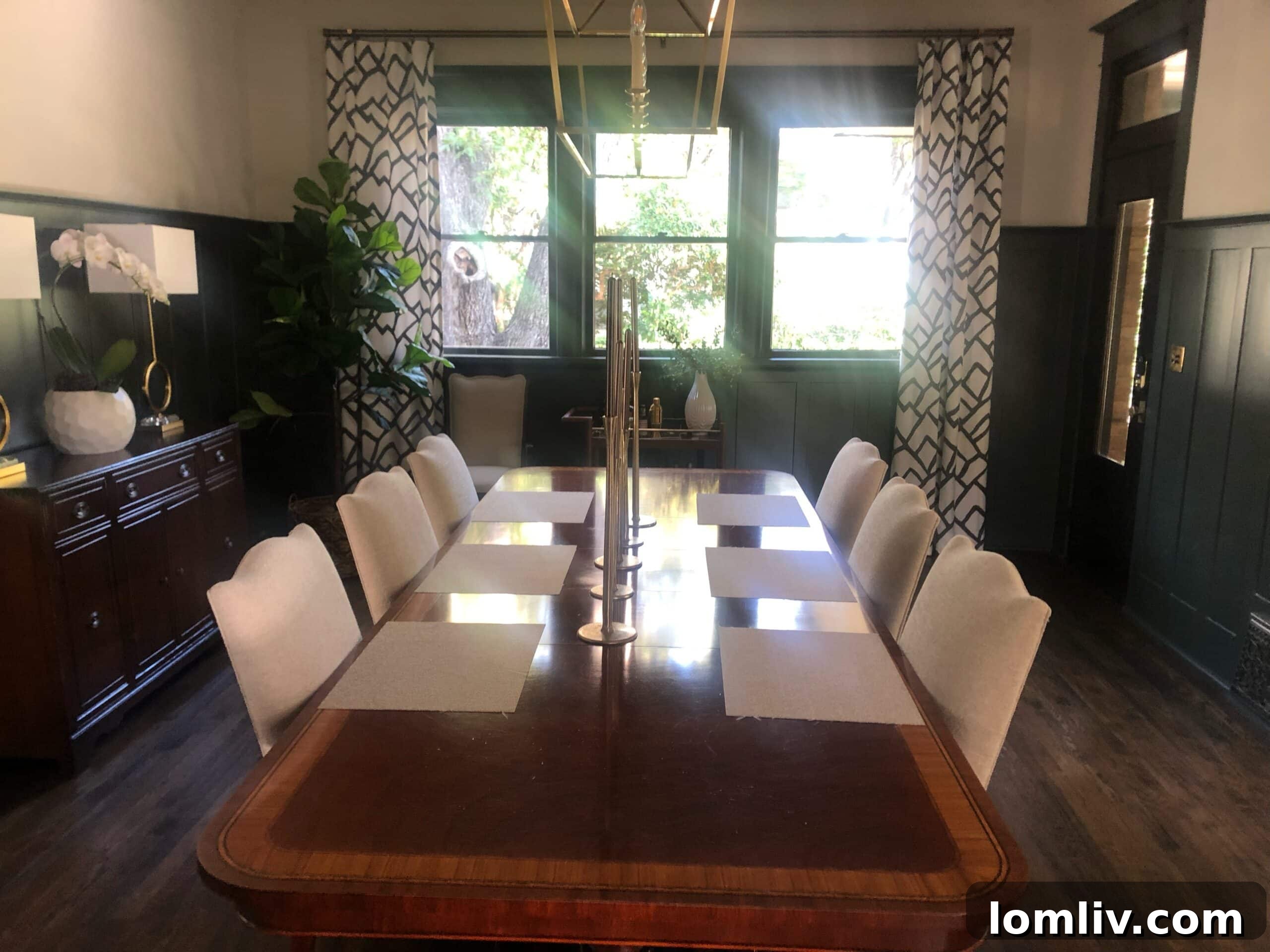 After renovation: Elegant entry and living room with grand staircase