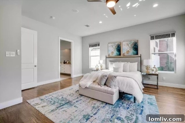 Luxurious primary bathroom with dual vanities, a freestanding tub, and a rainfall shower.