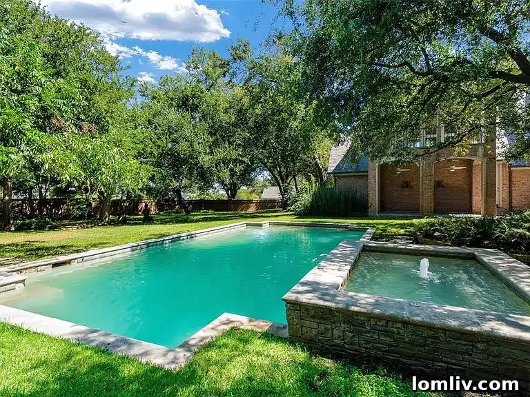 Classic, stately exterior of 31 Robledo Drive with circular drive and gas lanterns