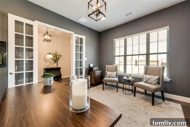 Elegant kitchen design with black and white quartz countertops, floor-to-ceiling cabinets, and a farmhouse sink.