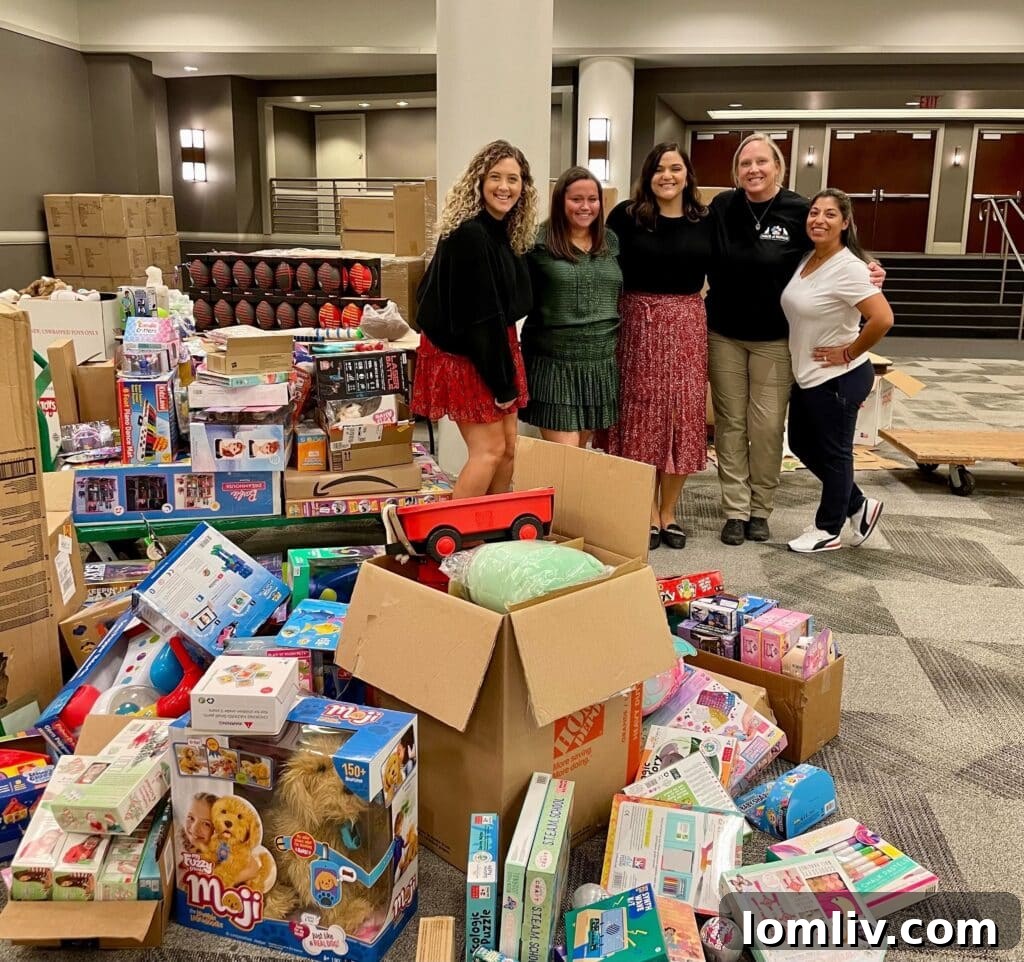 Rogers Healy and Associates Real Estate employees help organize toys during last year’s toy drive.