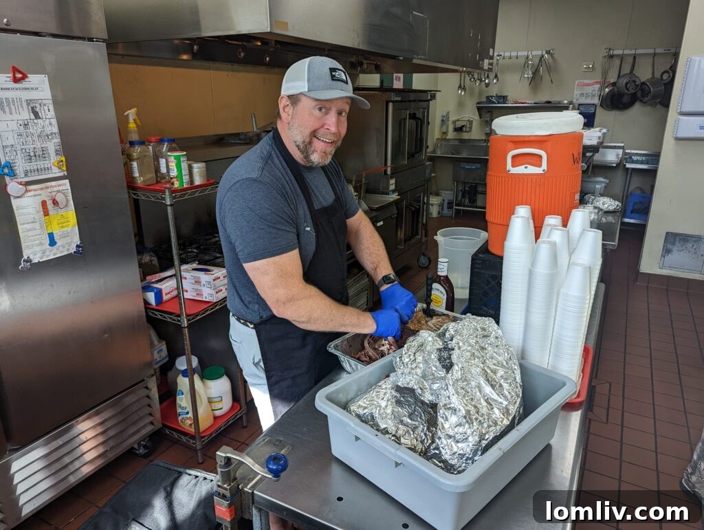 Eric Holmes serving food with a smile