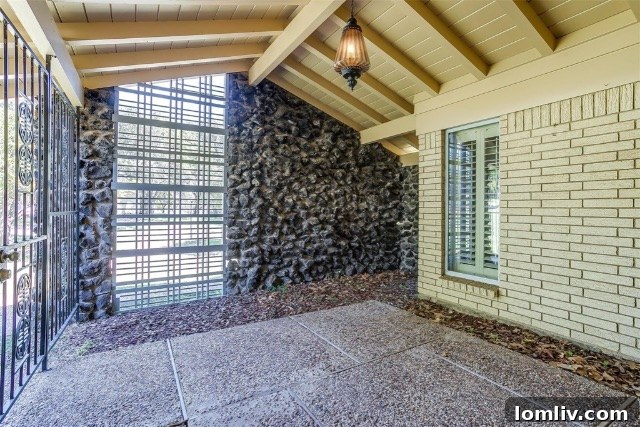 Mid-Century Modern living room with wood paneling and brick fireplace
