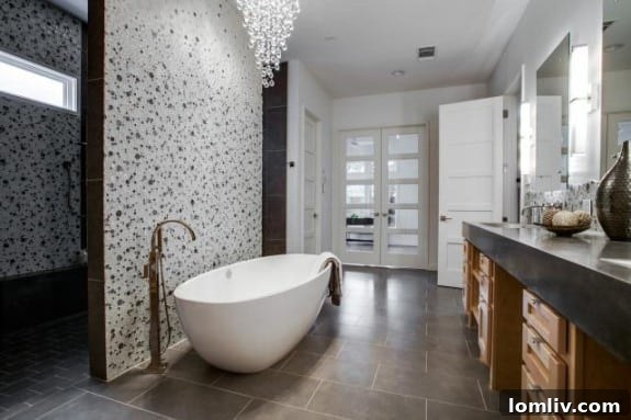 High-end master bathroom with a spacious walk-in shower featuring a rain showerhead, a sleek double vanity, and sophisticated tile work.