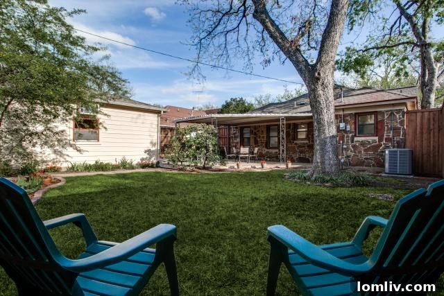 Rear view of the charming Tudor home at 5307 Morningside with ample backyard space
