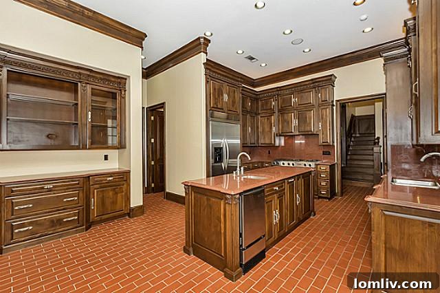 Gourmet kitchen featuring unique brick flooring, stainless steel appliances, and generous counter space