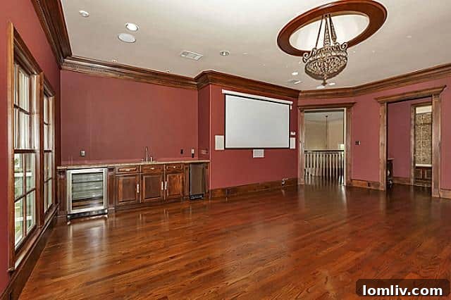 Dedicated media room with comfortable tiered seating and large screen for home entertainment in Heath TX luxury home