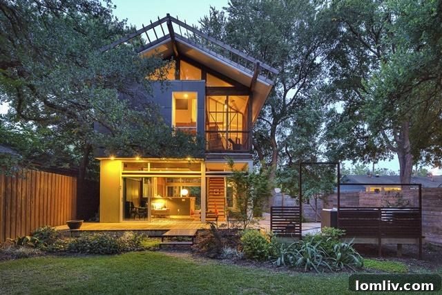 Front exterior view of 8643 Groveland at twilight, highlighting the warm glow from within and the distinctive modern architectural lines.