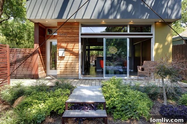 Spacious outdoor deck area at 8643 Groveland, perfect for relaxation and entertaining, surrounded by lush greenery.