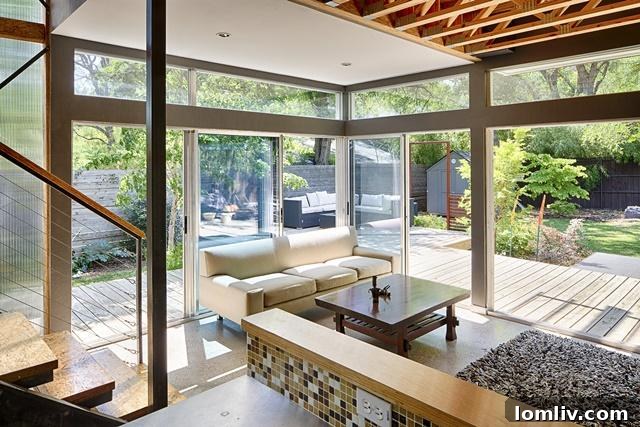 Bright and spacious living area at 8643 Groveland, featuring modern furnishings and abundant natural light from large windows.