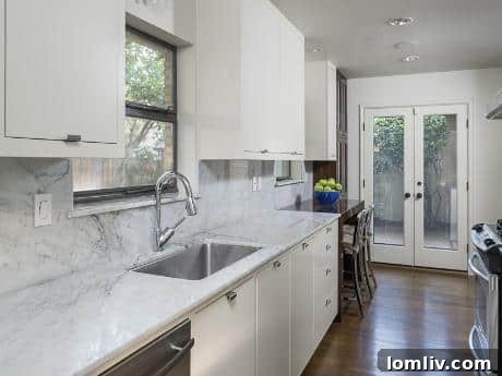 6806 Vada Drive - Kitchen - A beautifully renovated kitchen with marble countertops and stainless steel appliances.