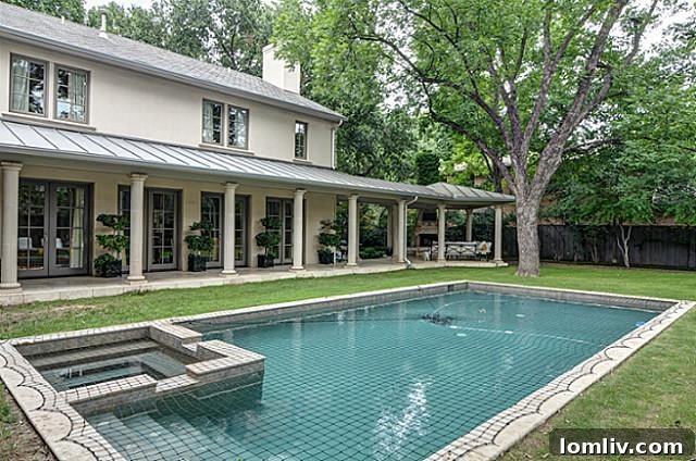 Oversized saltwater pool with safety netting in a private backyard oasis