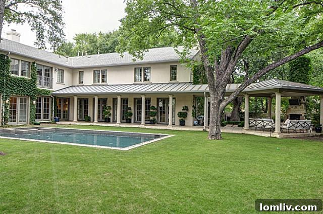 Rear exterior view of 4465 Rheims Place showcasing French doors and pool