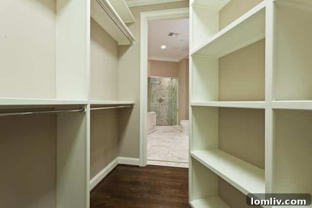 Spacious walk-in closet with custom shelving and ample storage in Ritz-Carlton unit #904