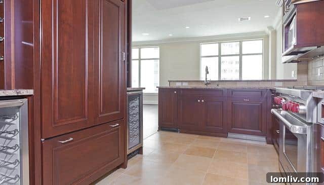 Gourmet kitchen with modern appliances and central island in Ritz-Carlton unit #904