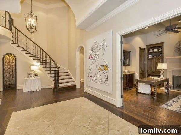 Elegant Curved Iron Staircase in Luxury Dallas Home Foyer