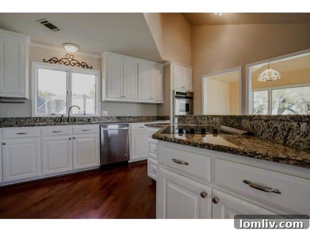 Modern Kitchen with Granite Counters and Ample Cabinetry