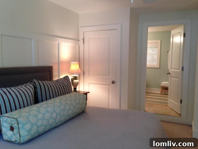 Overview of the backyard with the canal, boat lift, and screened porch