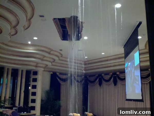Severe water damage visible in the ceiling of Deion Sanders' living room