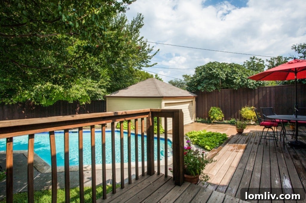 The refreshing swimming pool in the backyard, surrounded by a spacious deck, ideal for relaxation and entertaining.