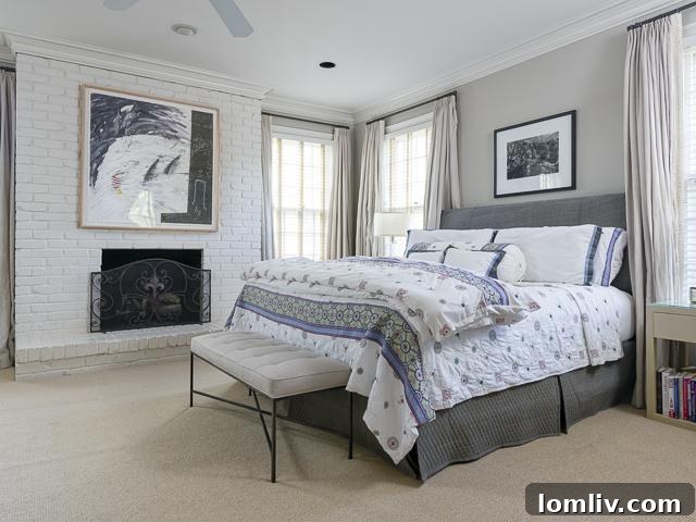 Spacious master bedroom with elegant decor and comfortable seating area