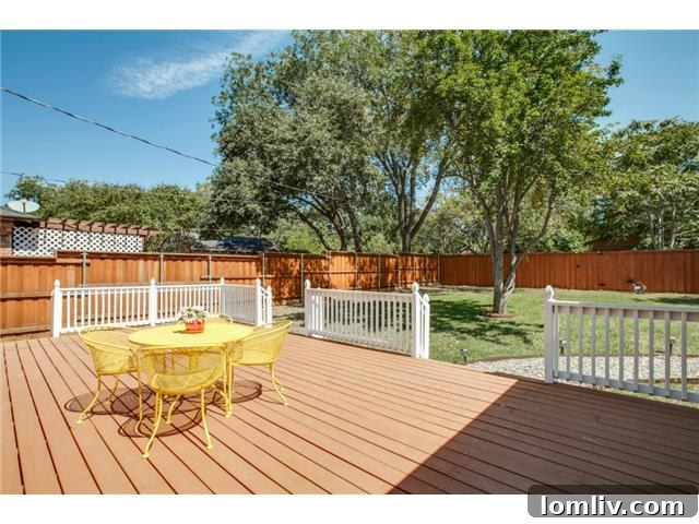 Expansive backyard deck with white railings, ideal for entertaining in a Dallas home.