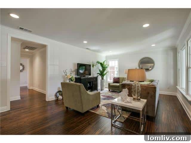 Spacious open living room with abundant natural light and hardwood flooring in a Dallas home.
