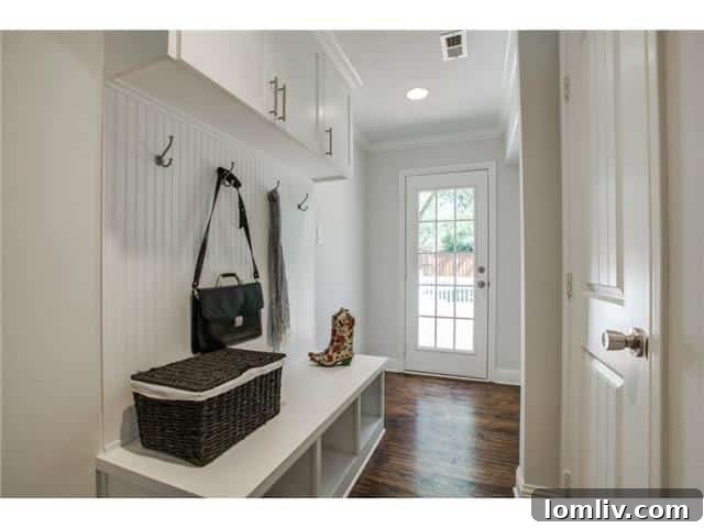 Well-organized mudroom and utility space leading to the backyard in a renovated Dallas home.