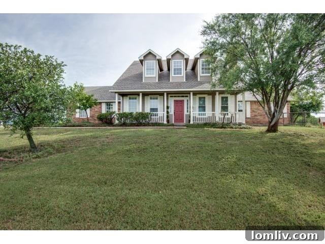 Stunning front exterior of the updated farmhouse at 8955 Santa Fe Trail, Celina, TX
