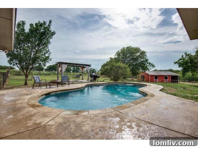 Expansive backyard featuring a sparkling pool and lush green space