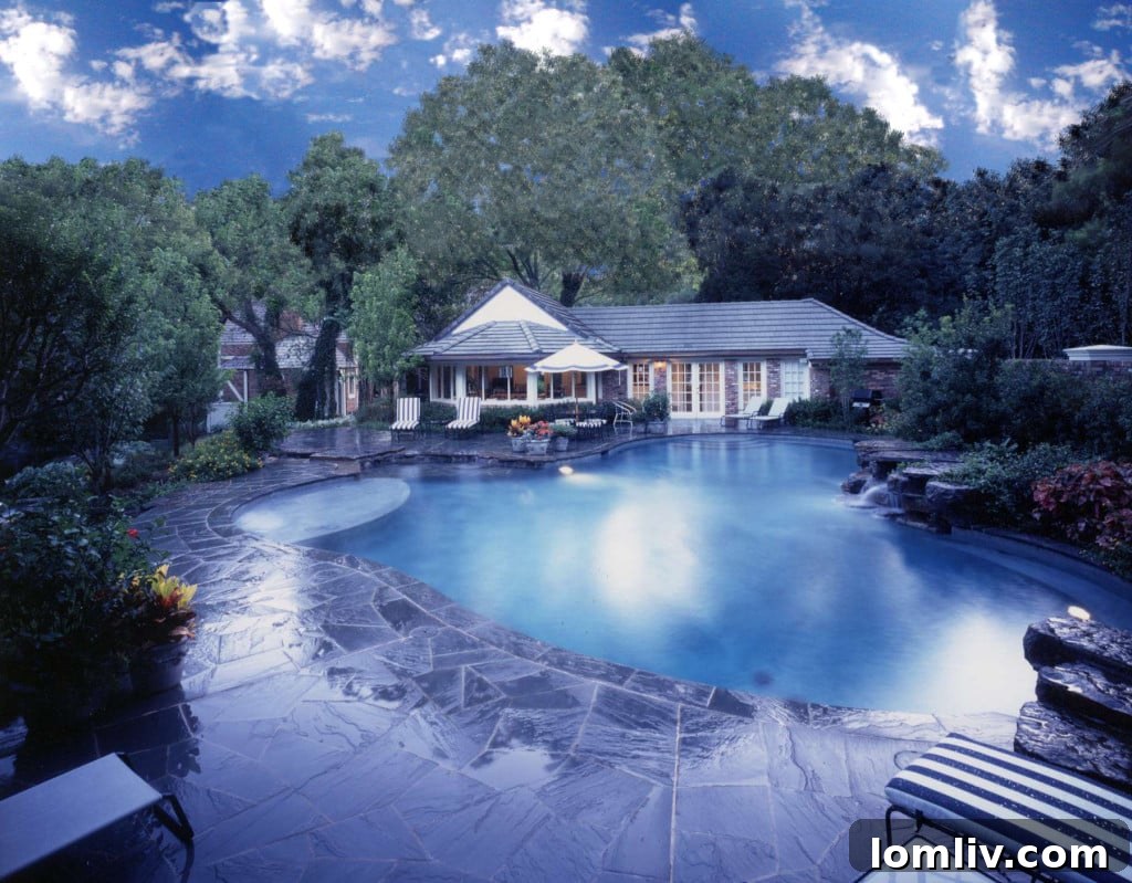 Expansive pool and spa area amidst lush landscaping at 9250 Meadowbrook Drive, Dallas