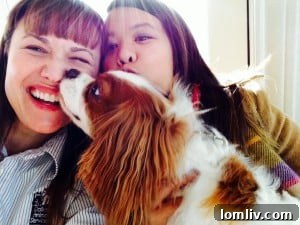 Bentley giving Dr. Cate McManus grateful licks