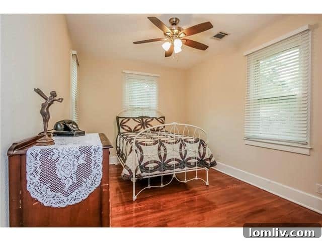 Kitchen sink area with unique peacock-inspired stained glass art