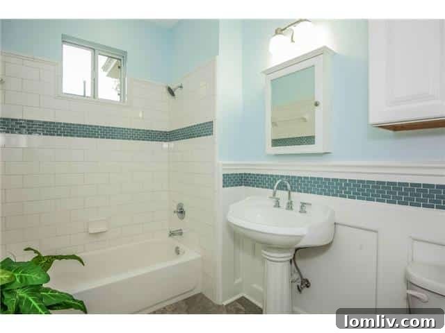 Updated bathroom with Travertine tile and glass accents