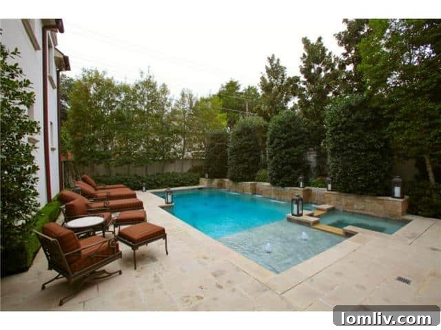 Troy Aikman's Highland Park Estate Now Commands $5.95 Million 19 Sparkling pool and spa nestled among privacy hedges, creating a private resort feel.