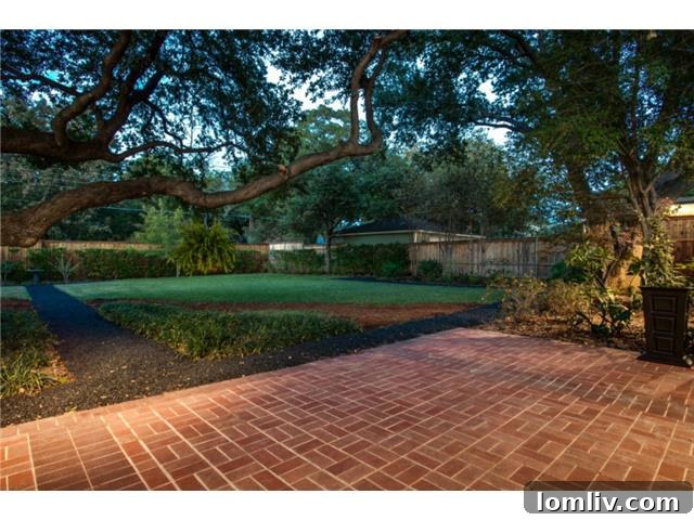 Expansive Backyard with Lush Greenery and Mature Live Oak Tree