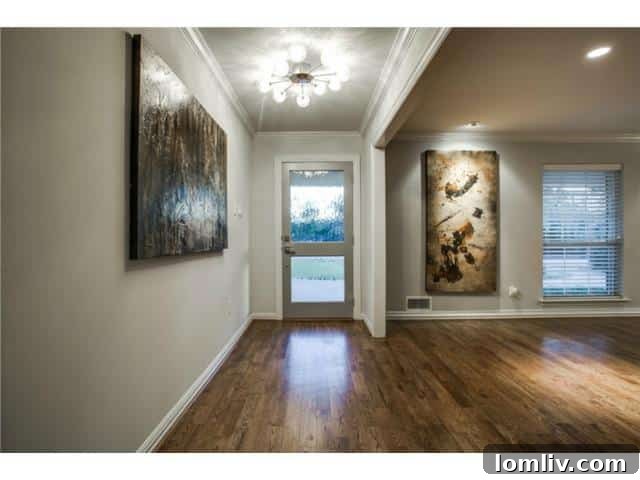 Elegant Entryway with Textured Glass Door and Hand-Scraped Hardwoods
