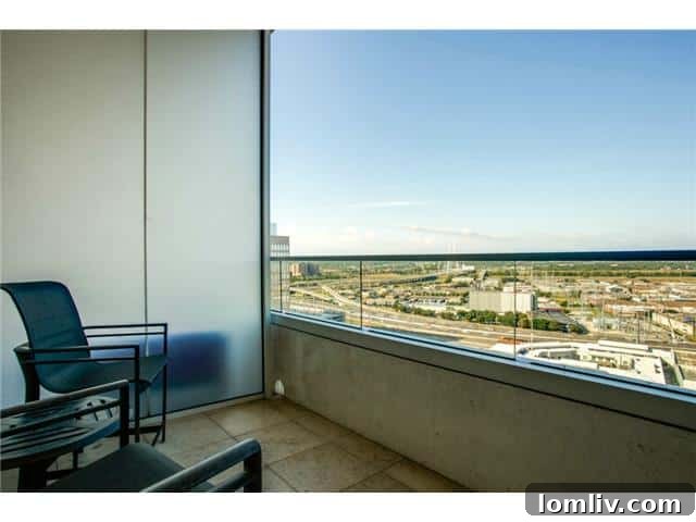 Unit 2001's private balcony offers stunning views of Victory Park and the Dallas skyline, perfect for relaxation.