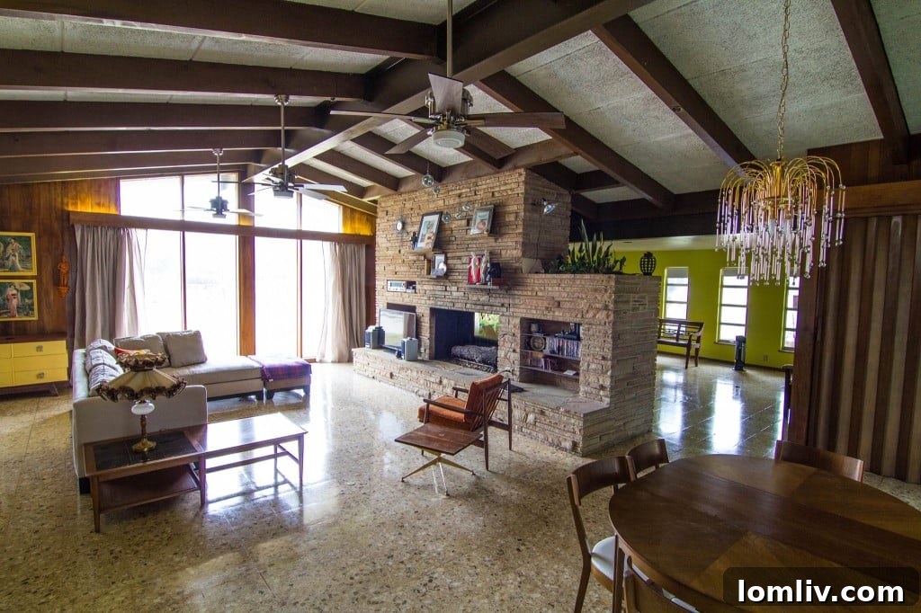The elegant living area with a stone double fireplace, separating two distinct spaces