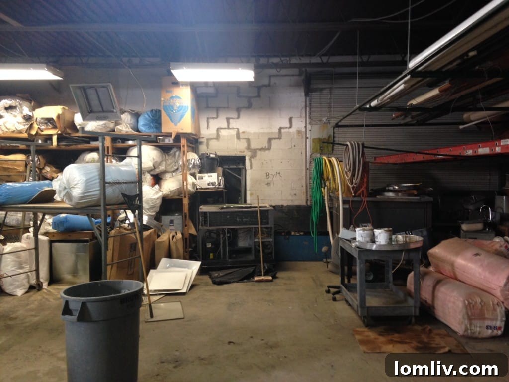 Initial view of the former mechanic's garage with cluttered interior