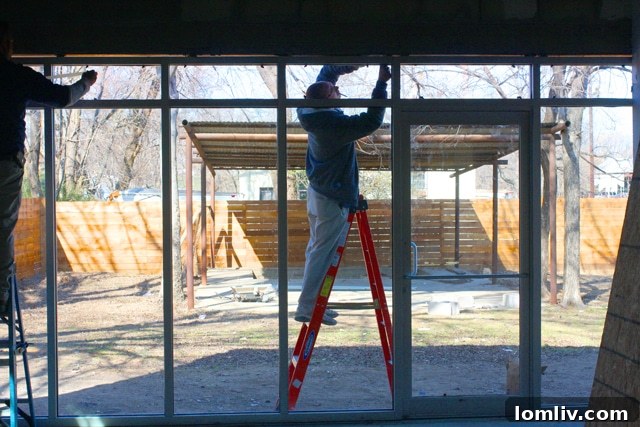 Living area showing large windows and exposed structural elements